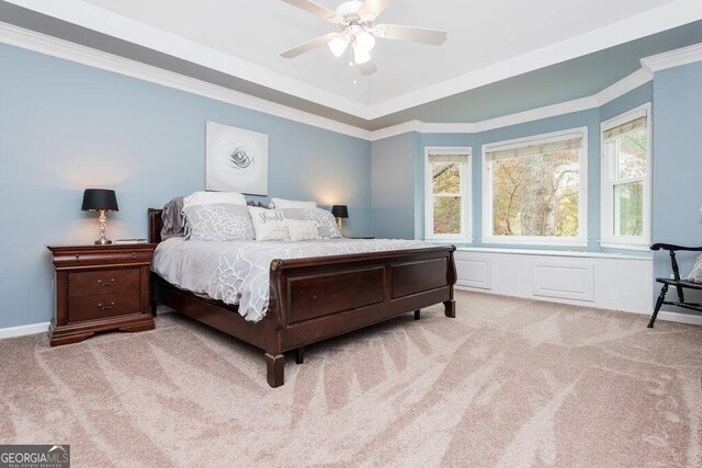 carpeted bedroom with ceiling fan and crown molding