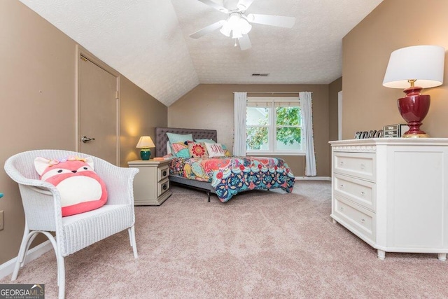 carpeted bedroom with ceiling fan, a textured ceiling, and lofted ceiling