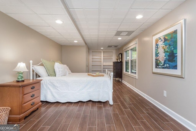 bedroom with dark hardwood / wood-style floors