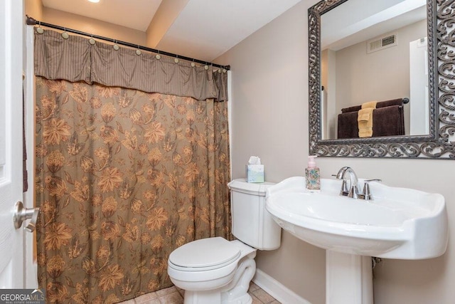 bathroom featuring tile patterned flooring and toilet