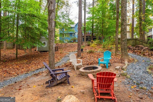 view of yard featuring a storage shed and a fire pit