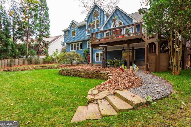 back of house featuring a patio, a yard, and a deck