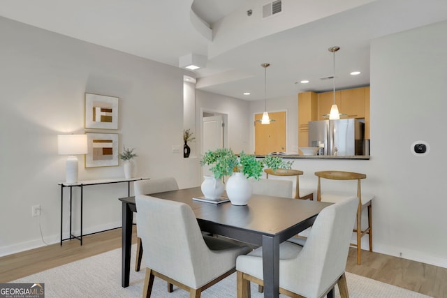 dining area with light wood-type flooring