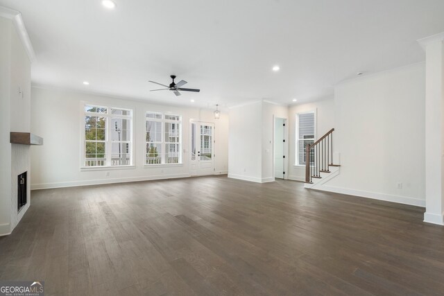 unfurnished living room with ceiling fan, dark hardwood / wood-style floors, and crown molding