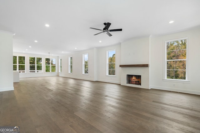 unfurnished living room with dark hardwood / wood-style floors, crown molding, and ceiling fan