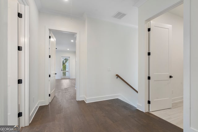 corridor with wood-type flooring and ornamental molding