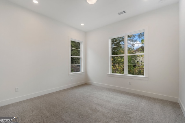 spare room with light carpet