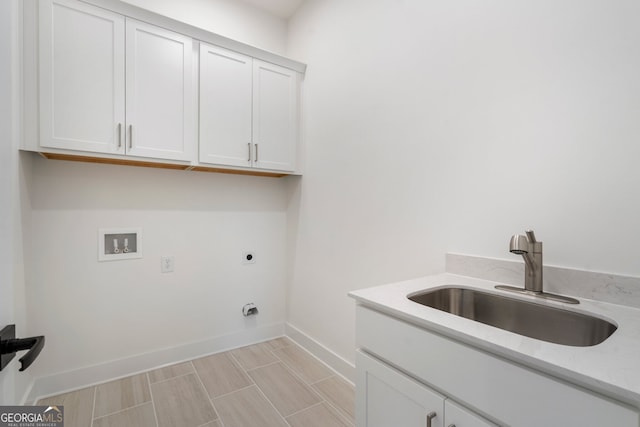 washroom with cabinets, electric dryer hookup, sink, and washer hookup