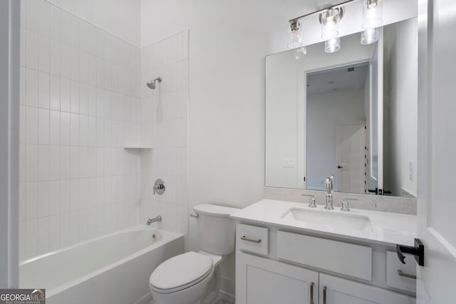 full bathroom with toilet, tiled shower / bath combo, and vanity