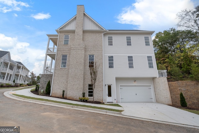 exterior space featuring a garage and a balcony