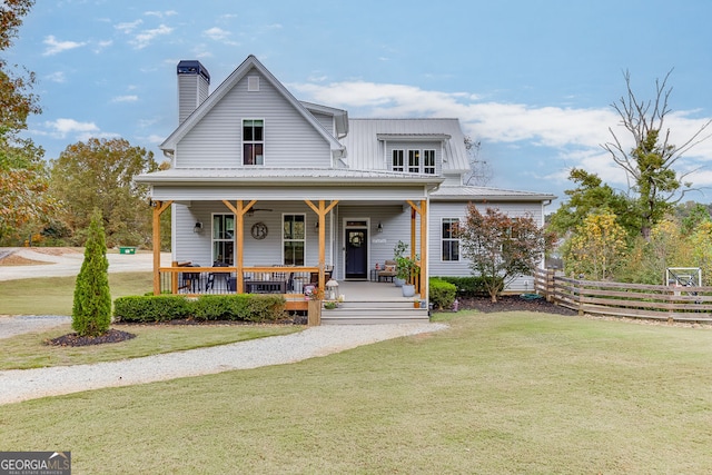 view of front of property with a front yard and covered porch