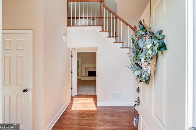 foyer featuring hardwood / wood-style flooring and a high ceiling