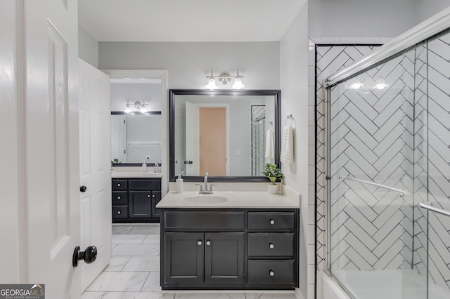 bathroom with bath / shower combo with glass door and vanity