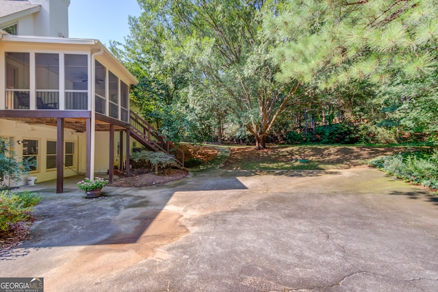 view of yard featuring a patio and a sunroom