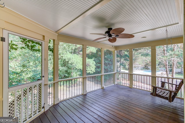 unfurnished sunroom with ceiling fan