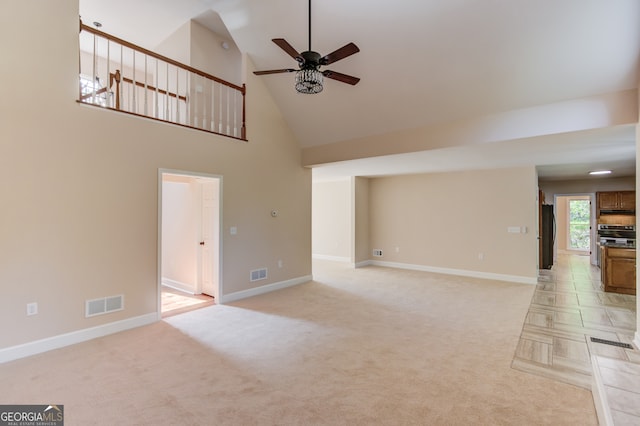 unfurnished living room with high vaulted ceiling, light colored carpet, and ceiling fan