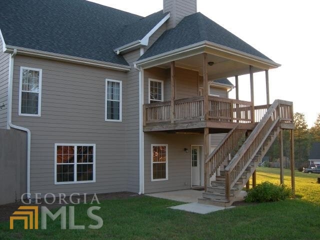 rear view of property with a lawn