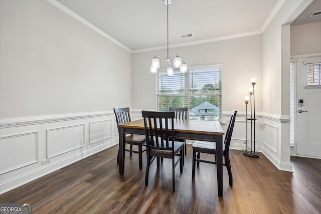 dining area with ornamental molding, a wealth of natural light, an inviting chandelier, and dark hardwood / wood-style floors