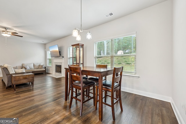 dining space with dark hardwood / wood-style flooring and ceiling fan