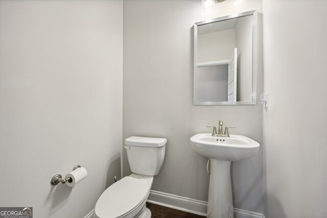 bathroom featuring toilet and hardwood / wood-style floors