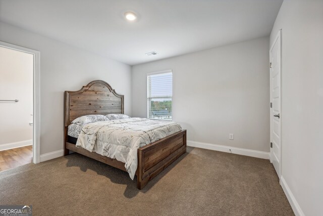 carpeted bedroom with ensuite bath