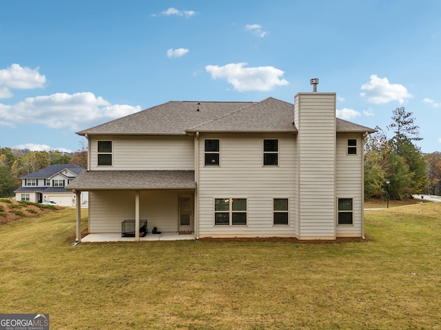 rear view of house with a lawn and a patio area