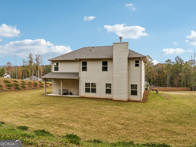 back of house featuring a patio and a yard