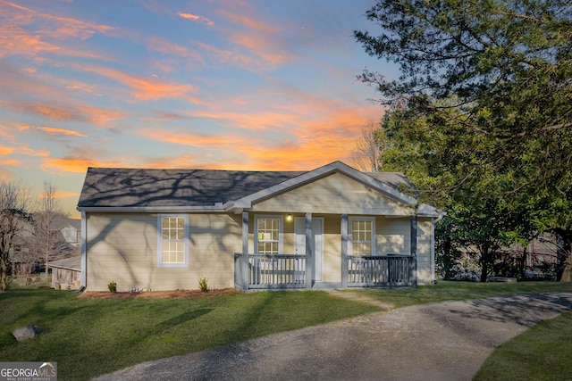 view of front of home featuring covered porch and a front yard