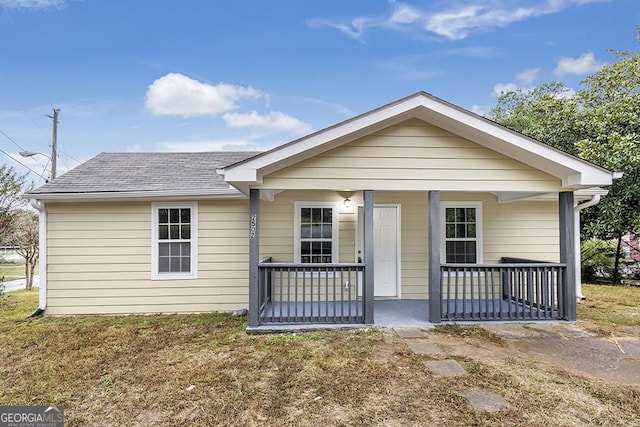 view of front of house with covered porch and a shingled roof