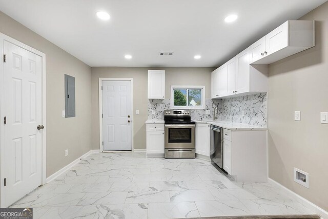 kitchen featuring electric panel, stainless steel range with electric cooktop, light stone countertops, sink, and white cabinets