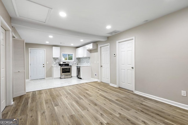 unfurnished living room with light wood-style flooring, baseboards, recessed lighting, and attic access