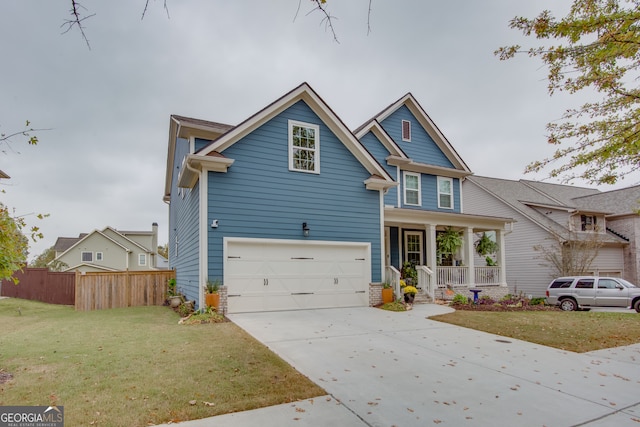 view of front of property featuring a garage, a front yard, and covered porch