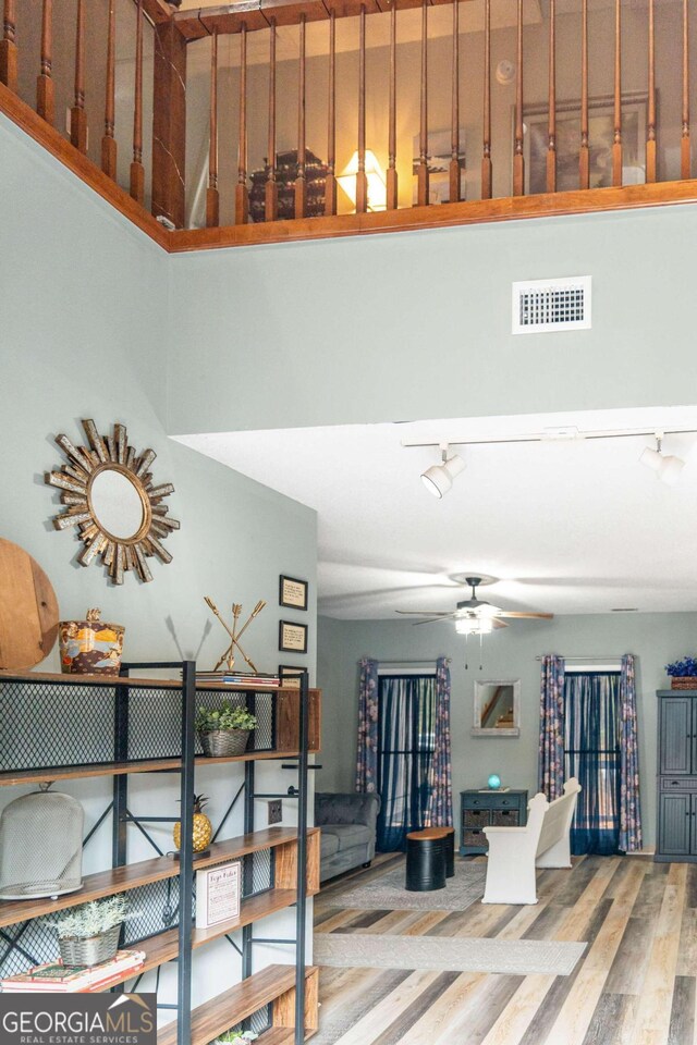 interior space with ceiling fan, hardwood / wood-style floors, and a textured ceiling