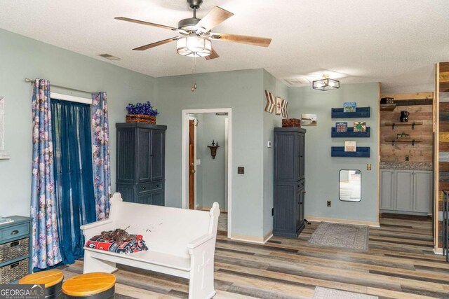 interior space with hardwood / wood-style floors and ceiling fan