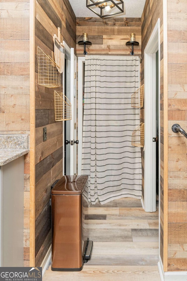 bathroom featuring wooden walls