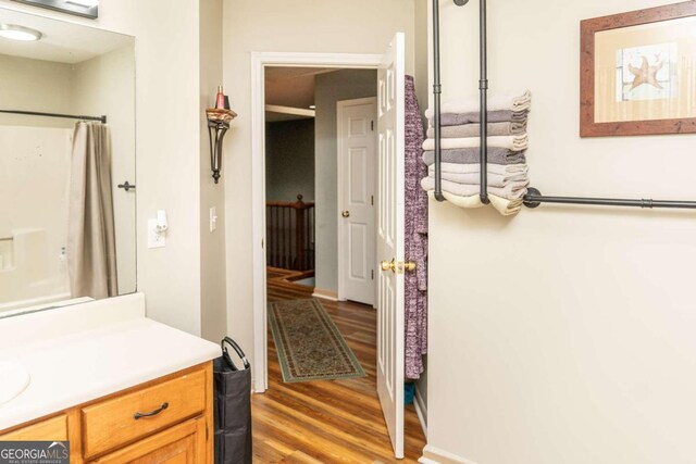 bathroom with vanity, wood-type flooring, and toilet