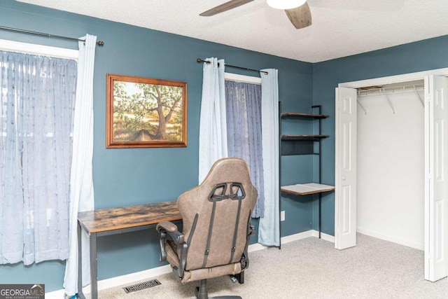 office area featuring carpet, a textured ceiling, and ceiling fan