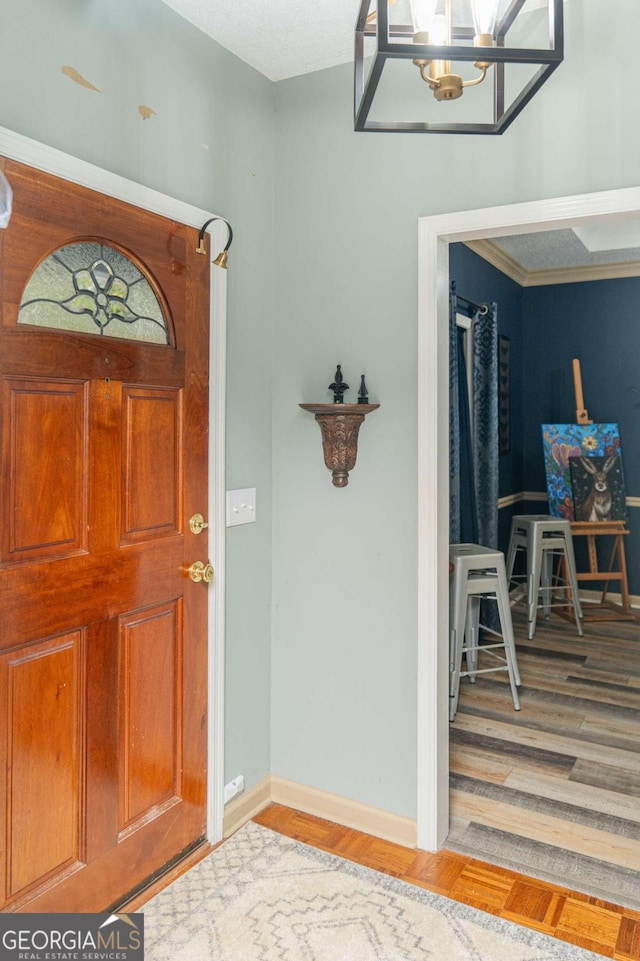 foyer entrance featuring wood-type flooring and a notable chandelier