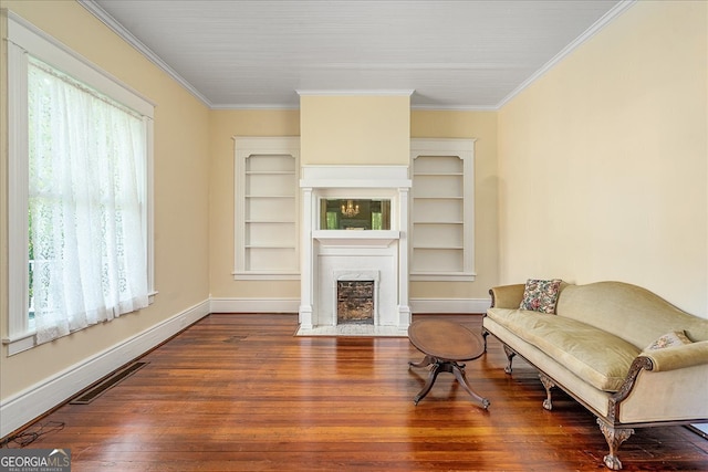 living room with wood-type flooring and ornamental molding