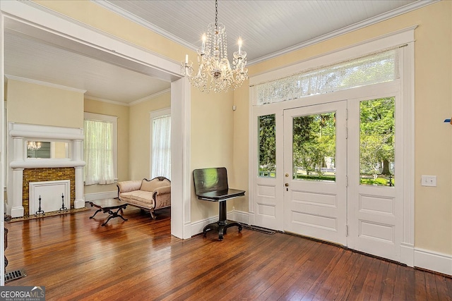 entrance foyer featuring wood-type flooring, a notable chandelier, and ornamental molding