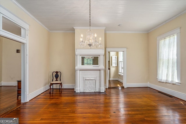 interior space featuring dark hardwood / wood-style floors, crown molding, and an inviting chandelier