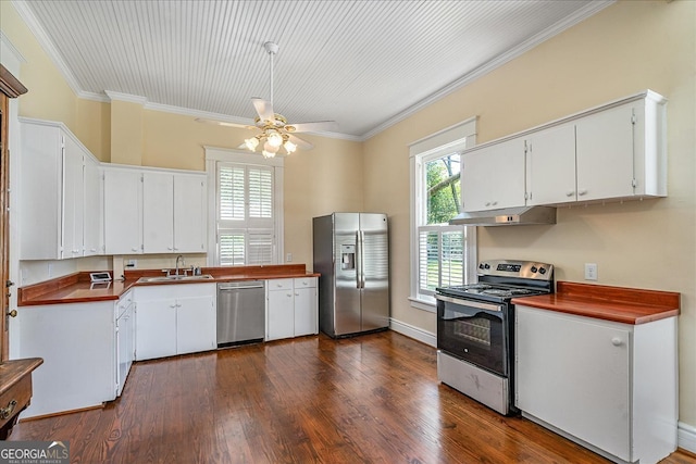 kitchen with white cabinetry, stainless steel appliances, exhaust hood, and crown molding