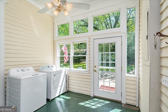 washroom featuring ceiling fan, a wealth of natural light, separate washer and dryer, and dark hardwood / wood-style floors