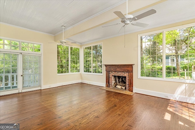 interior space featuring a fireplace, ceiling fan, and plenty of natural light