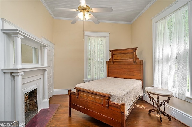 bedroom with dark wood-type flooring, ceiling fan, and crown molding