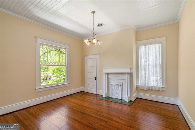 unfurnished living room featuring wood-type flooring, a notable chandelier, and crown molding