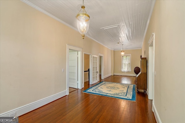 entrance foyer with ornamental molding and dark wood-type flooring