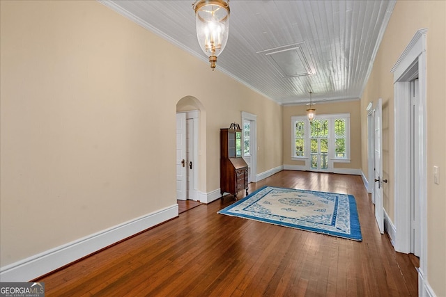 interior space featuring dark wood-type flooring, french doors, and ornamental molding