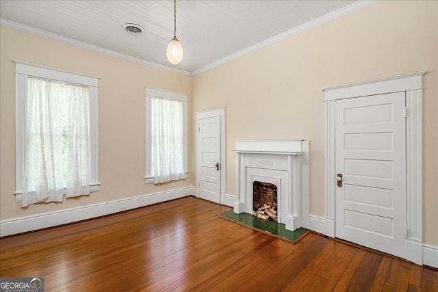 unfurnished living room with a brick fireplace, hardwood / wood-style flooring, and ornamental molding