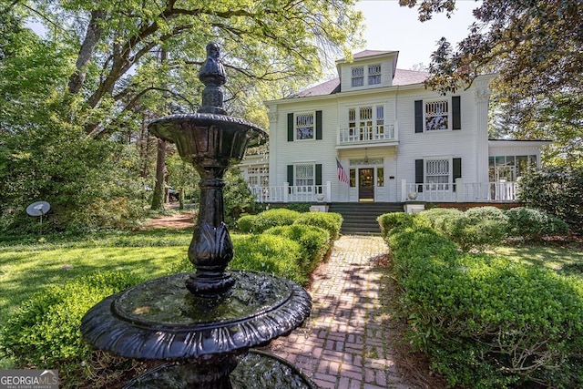 view of front of house with a porch and a front lawn